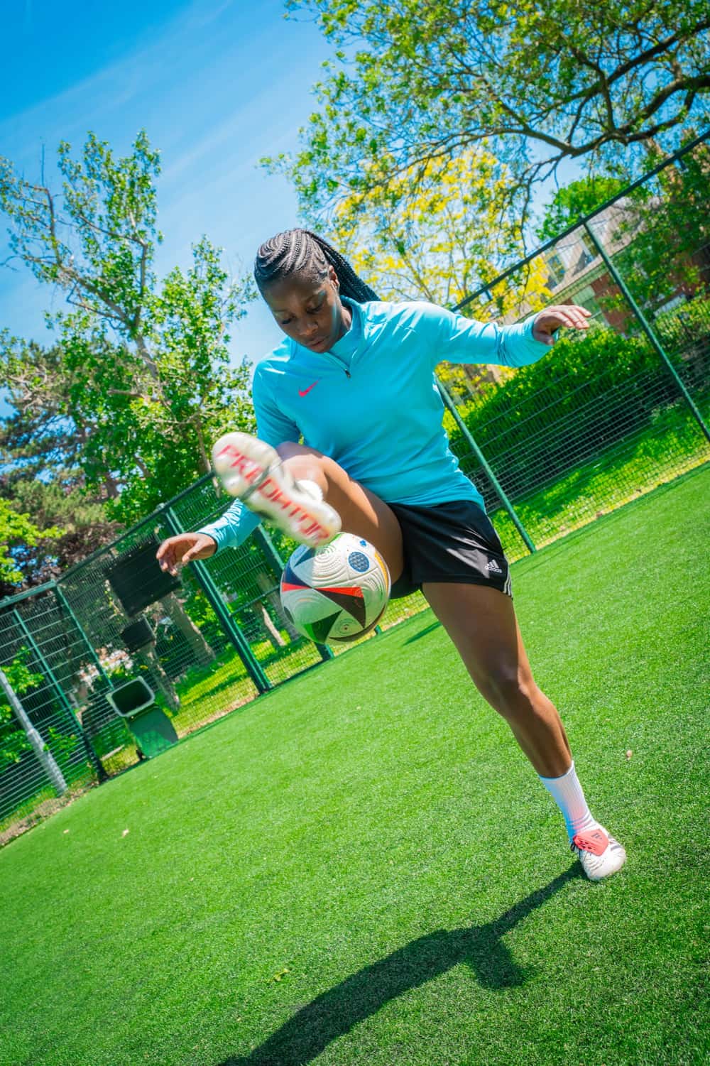 A footballer flicking the ball up on a pitch